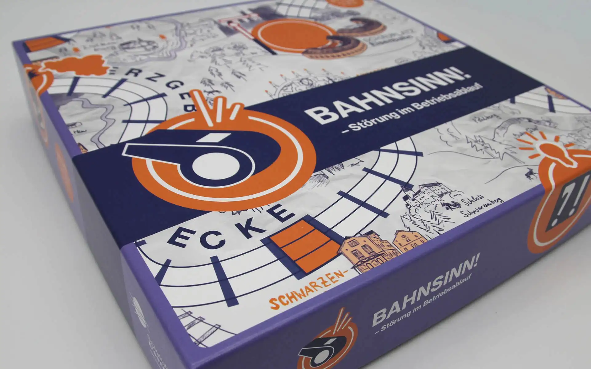 Spielschachtel des Brettspiels Bahnsinn! mit grafischem Streckenplan und Signalmotiv